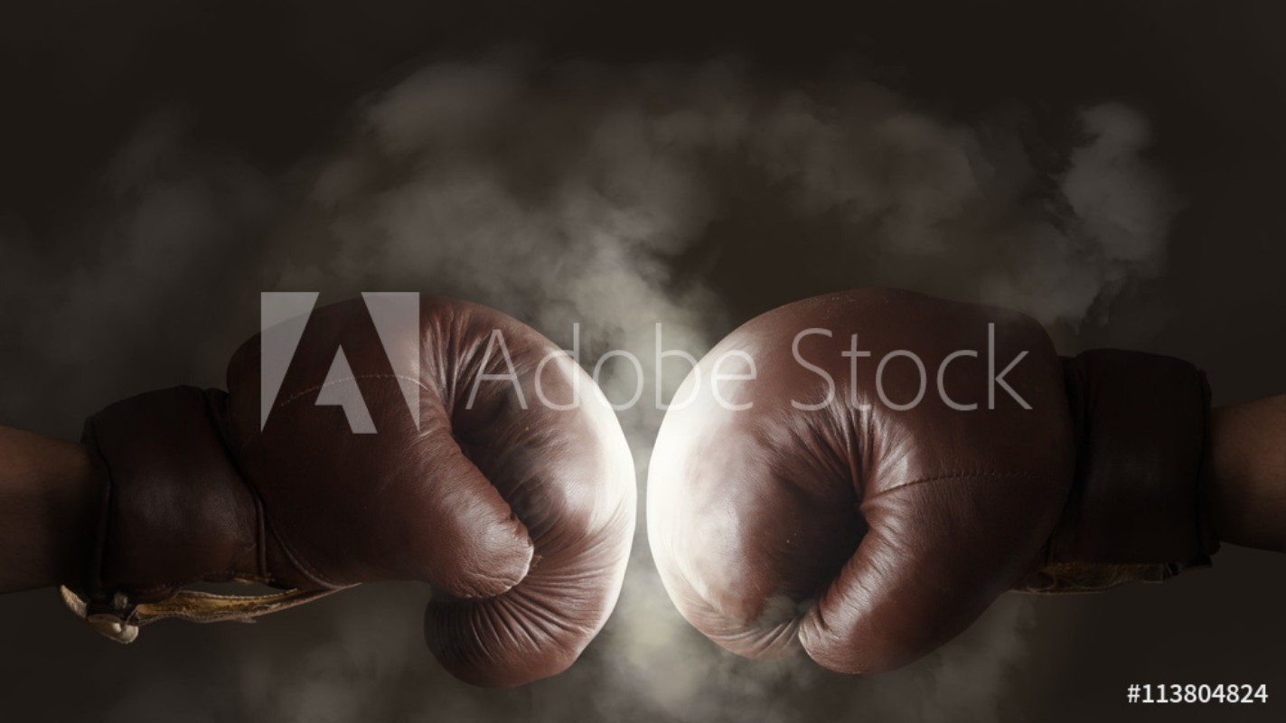 Two old brown boxing gloves hit together from Wallmural | Wallpassion