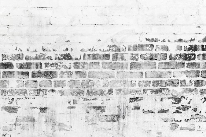 Picture of Old brick wall with damaged white paint layer