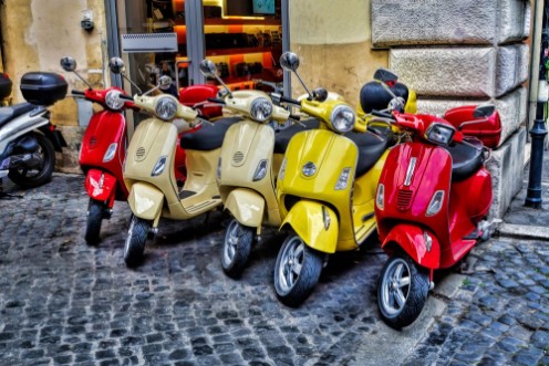 Bild på Scooters are parked on the city street in Rome Italy