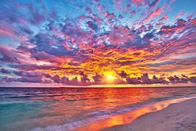 Colorful sunset over ocean on Maldives photowallpaper Scandiwall