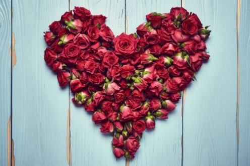 Picture of Heart shape of roses on wooden background