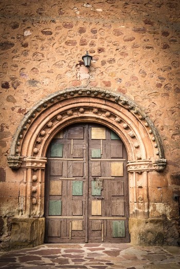 Bild på Ancient wooden door on a stone made wall