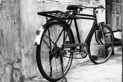Bild på Black and white photo of vintage bicycle - film grain filter effect styles