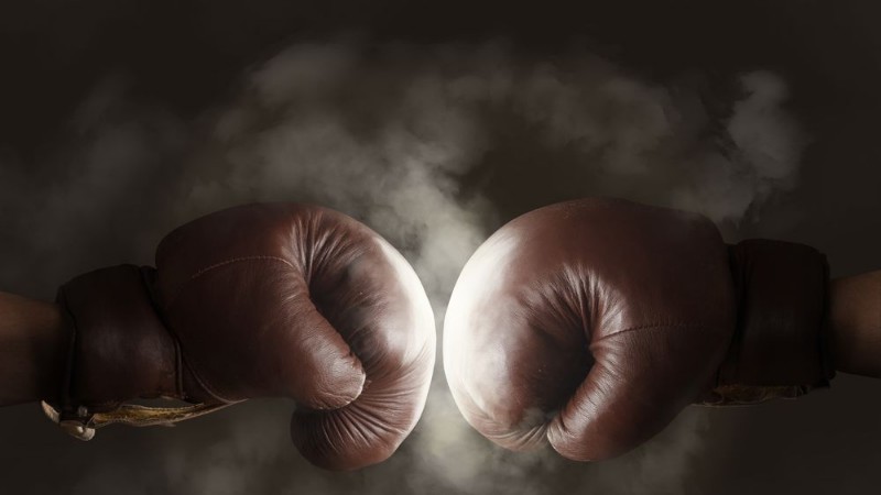 Bild på Two old brown boxing gloves hit together