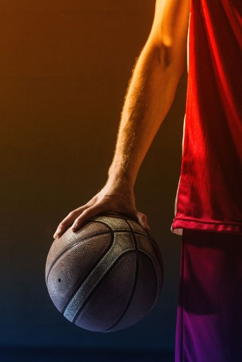 Bild på Close up on basketball held by basketball player
