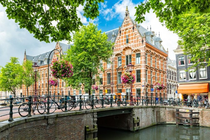 Picture of Typical canal side cityscape of Amsterdam opposite from the 17th century HQ of the Dutch East India Company now used by the University of Amsterdam