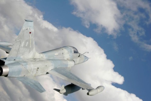 Afbeeldingen van Fighter Jet Against White Clouds And Blue Sky