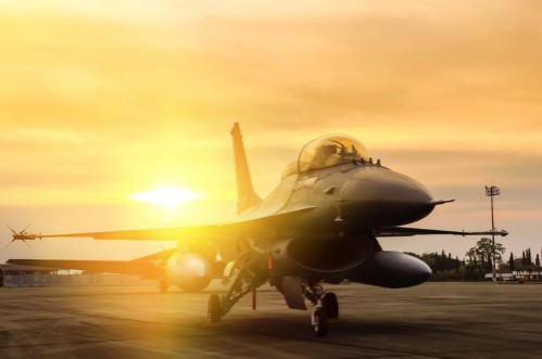 Afbeeldingen van F16 falcon fighter jet parked  on sunset  background 