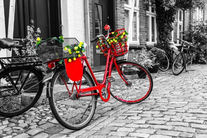 Bild på Retro vintage red bicycle on cobblestone street in the old town