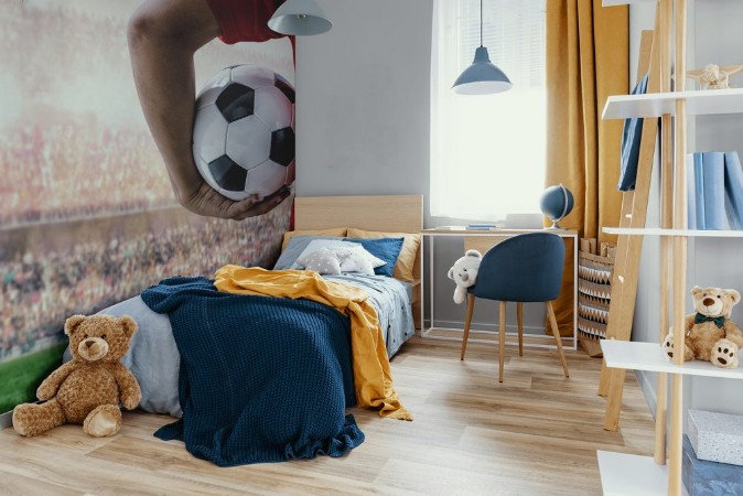 Afbeeldingen van Soccer football player in red team concept holding soccer ball in the stadium