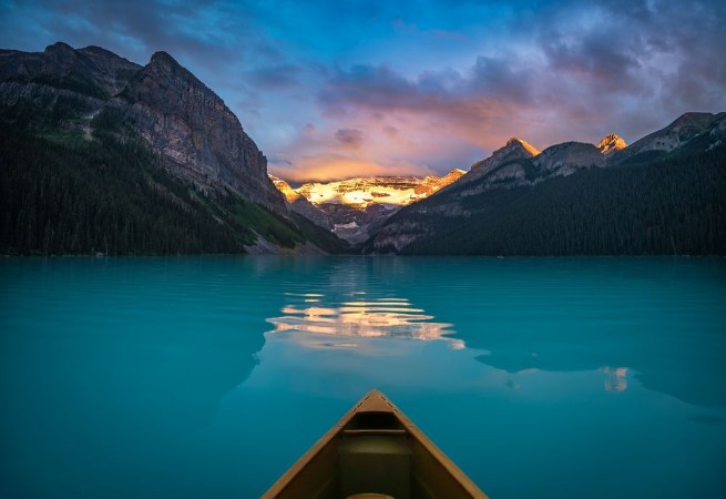 Picture of Viewing snowy mountain in rising sun from a canoe