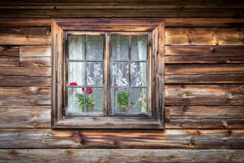 Bild på The old window of old wooden house Background of wooden walls
