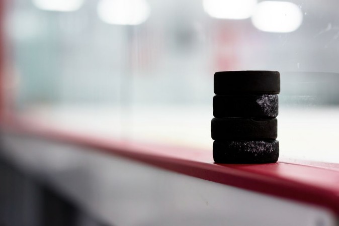 Picture of Hockey pucks along the boards