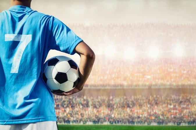 Afbeeldingen van Soccer football player in blue team concept holding soccer ball
