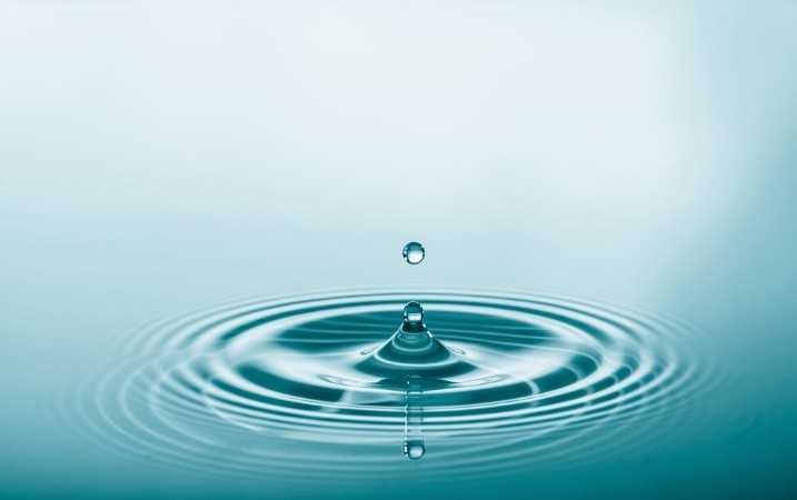 Picture of Water drop falling and drips on water mirror Water drop splash and make perfect circles on water surface