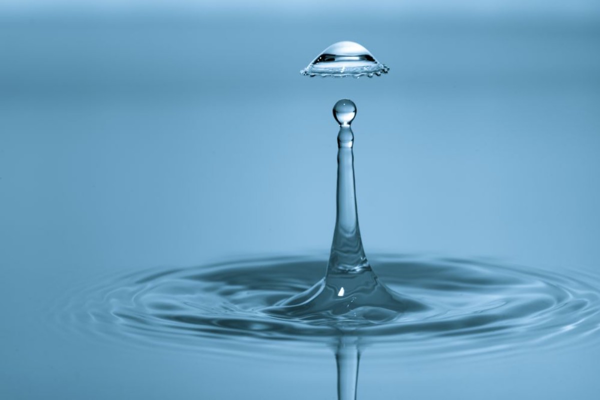 Picture of Water drop falling and drips on water mirror Water drop splash and make perfect circles on surface
