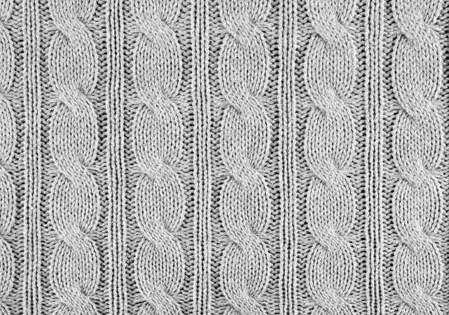 Afbeeldingen van Grey knitted textured background with a pattern closeup
