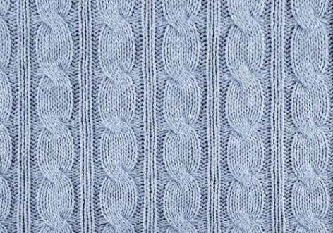 Afbeeldingen van Blue knitted textured background with a pattern closeup
