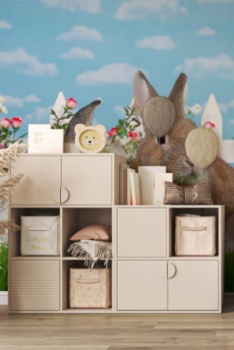 Image de Brown dwarf rabbit sitting in green grass next to white and brown lop eared bunny facing viewer White picket fence with small pink roses Blue background sky with clouds Copy space
