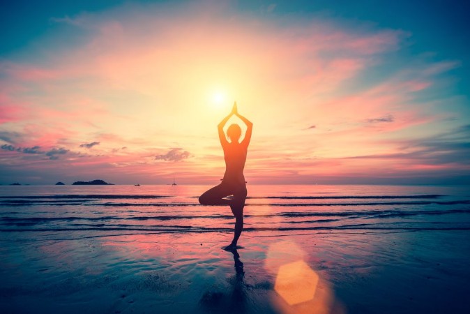 Silhouette yoga girl on the background of stunning sea and sunset Fitness meditation and healthy lifestyle photowallpaper Scandiwall