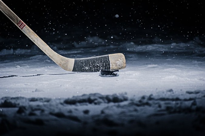 Picture of Hockey Stick and Puck on the Ice Rink