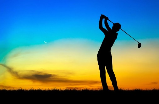 Picture of Silhouette golfer playing golf during beautiful sunset