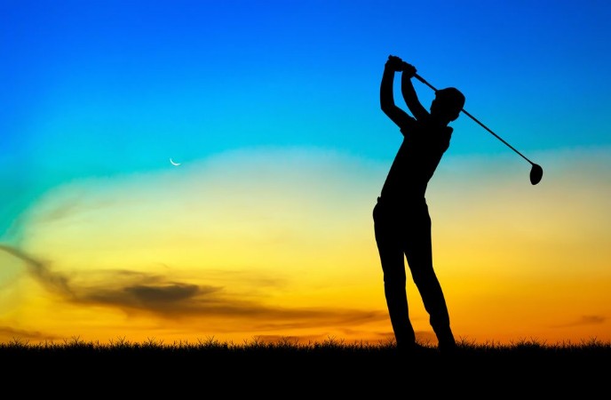 Bild på Silhouette golfer playing golf during beautiful sunset