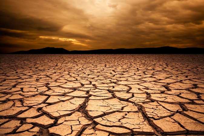 Picture of Dramatic sunset over cracked earth Desert landscape background