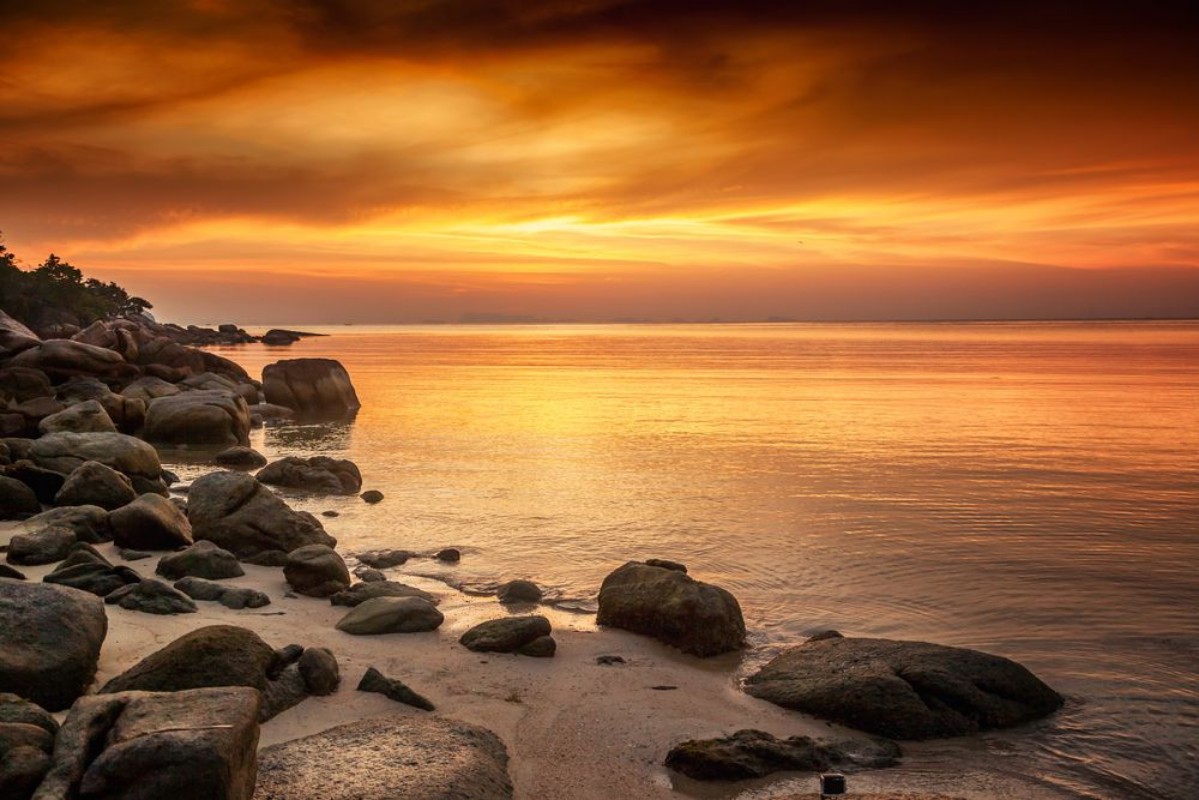Bild på A beautiful rocky beach at sunset