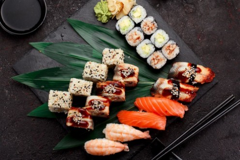 Afbeeldingen van Japanese cuisine Sushi set on a stone plate and dark concrete background