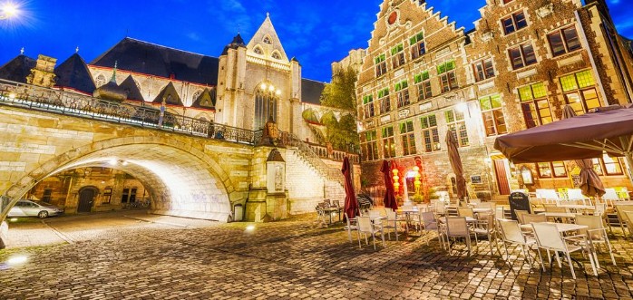 Afbeeldingen van GENT BELGIUM - MARCH 2015 Tourists visit ancient medieval city at night Gent attracts more than 1 million people annually