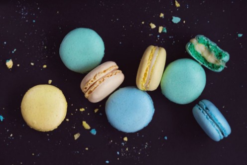 Afbeeldingen van Macaroons on dark background colorful french cookies macarons The broken macarons with crumbs