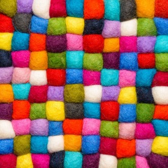 Afbeeldingen van Color wool background - balls of syntetic wool yarn - geometric rainbow pattern