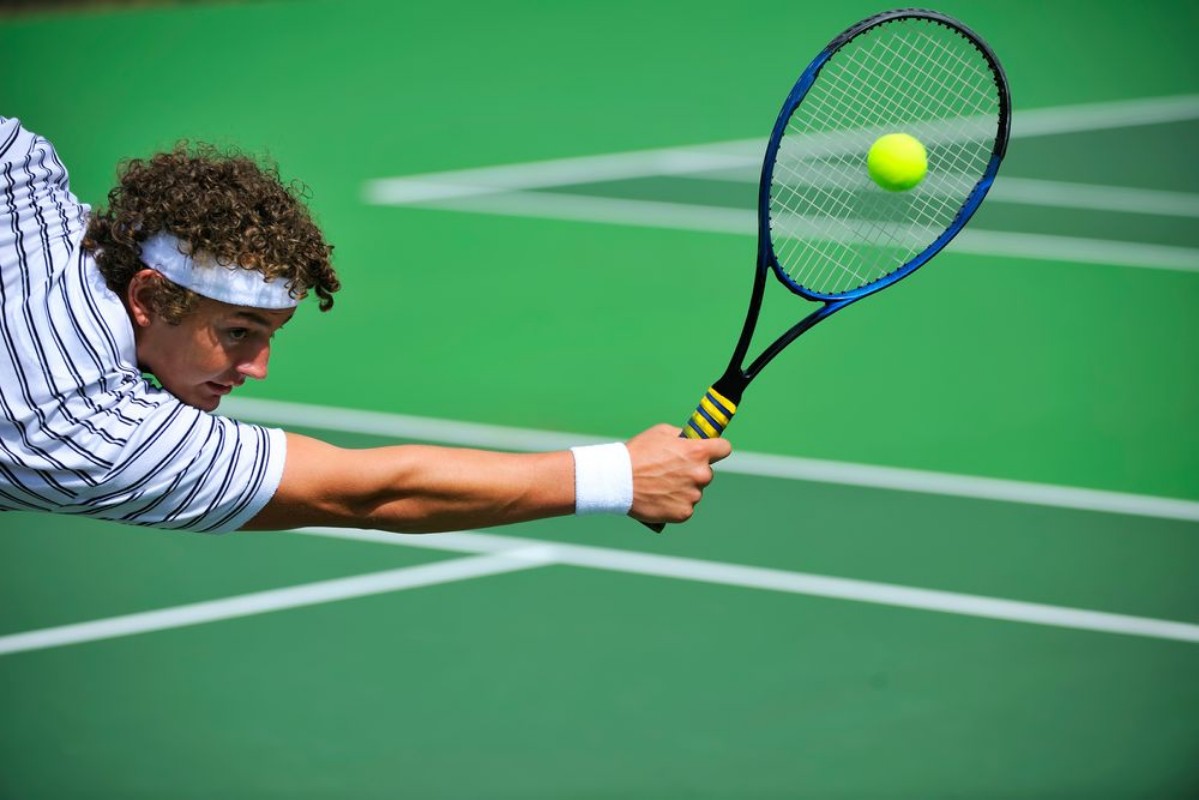 Picture of A tennis player stretches to make the shot