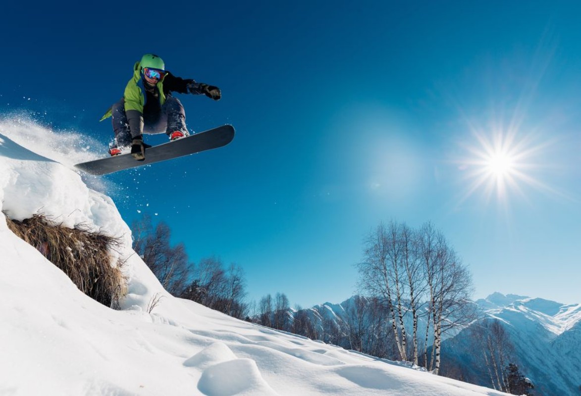 Afbeeldingen van Snowboarder is jumping with snowboard