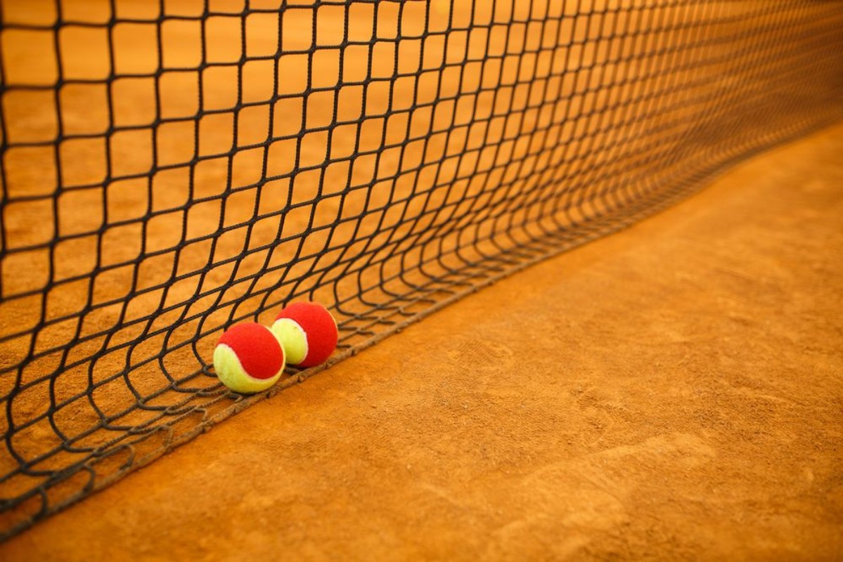 Afbeeldingen van Tennis red ball on a clay tennis court orange color