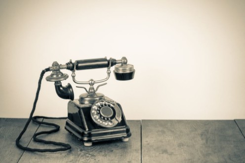 Picture of Vintage background with old rotary telephone on wood table