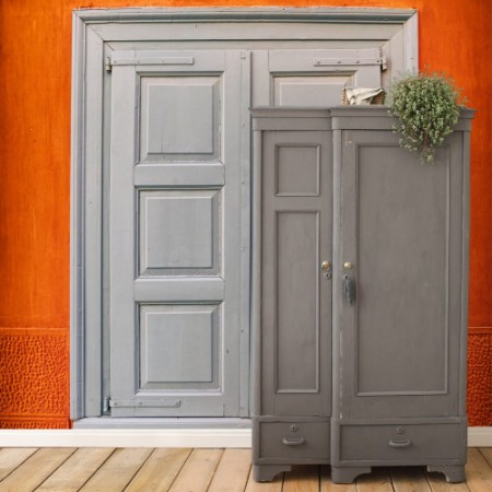 Image de Grey closed shutters window on vibrant orange wall filtered