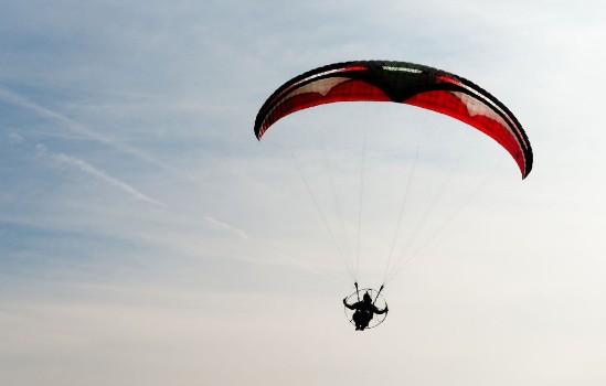 Bild på One Man Rides Flies Ultralight Flying Through Blue Sky