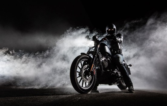 Picture of High power motorcycle chopper with man rider at night