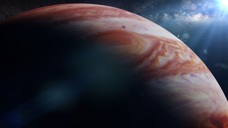 Afbeeldingen van Planet Jupiter lit by the Sun in front of the Milky Way 