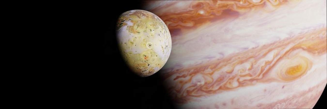 Jupiters moon Io in front of the planet Jupiter photowallpaper Scandiwall