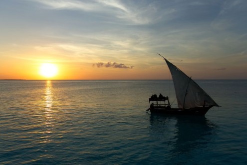 Afbeeldingen van Stunning sunset captured north on Zanzibar Tanzania Africa Sailboat passing by
