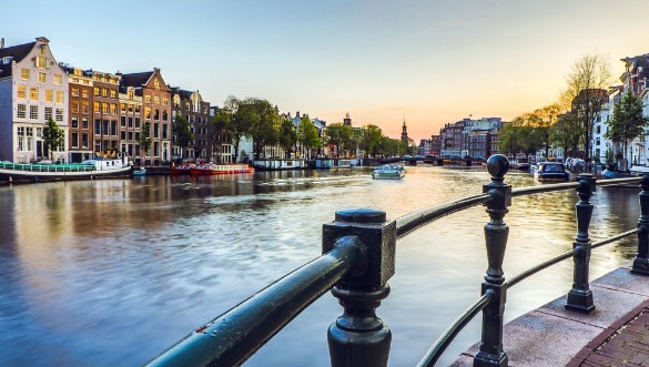 Afbeeldingen van The most famous canals and embankments of Amsterdam city during sunset General view of the cityscape and traditional Netherlands architecture