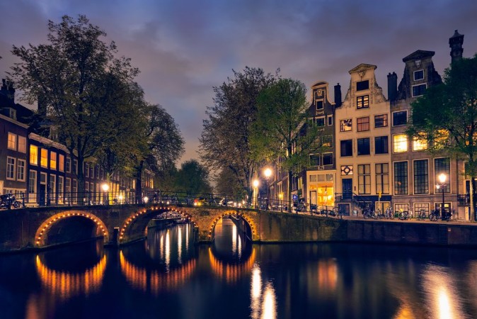 Picture of Amterdam canal bridge and medieval houses in the evening