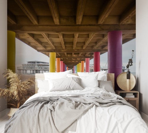 Image de Shot under pier with color painted columns on the beach at sunset