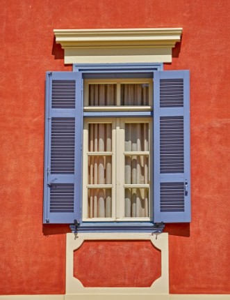 Bild på Elegant vintage window on orange house wall