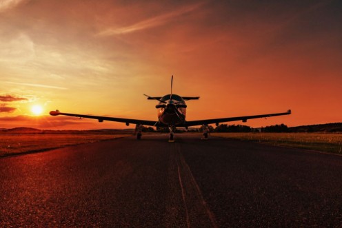 Picture of Single turboprop aircraft on evening runway