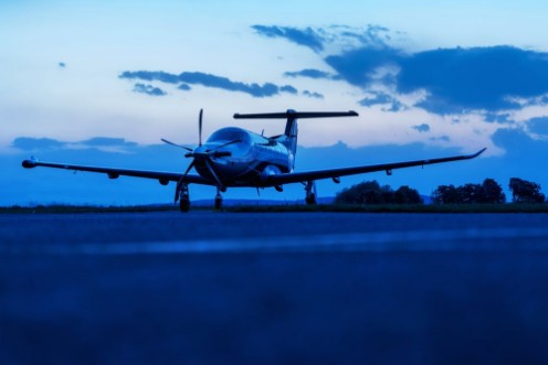 Bild på Single turboprop aircraft on evening runway