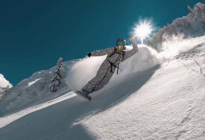 Afbeeldingen van Snowboarder rides in cloud of powder snow